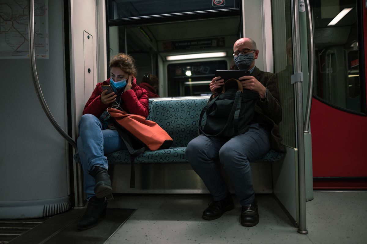 Commuter watching a video on a phone screen while travelling