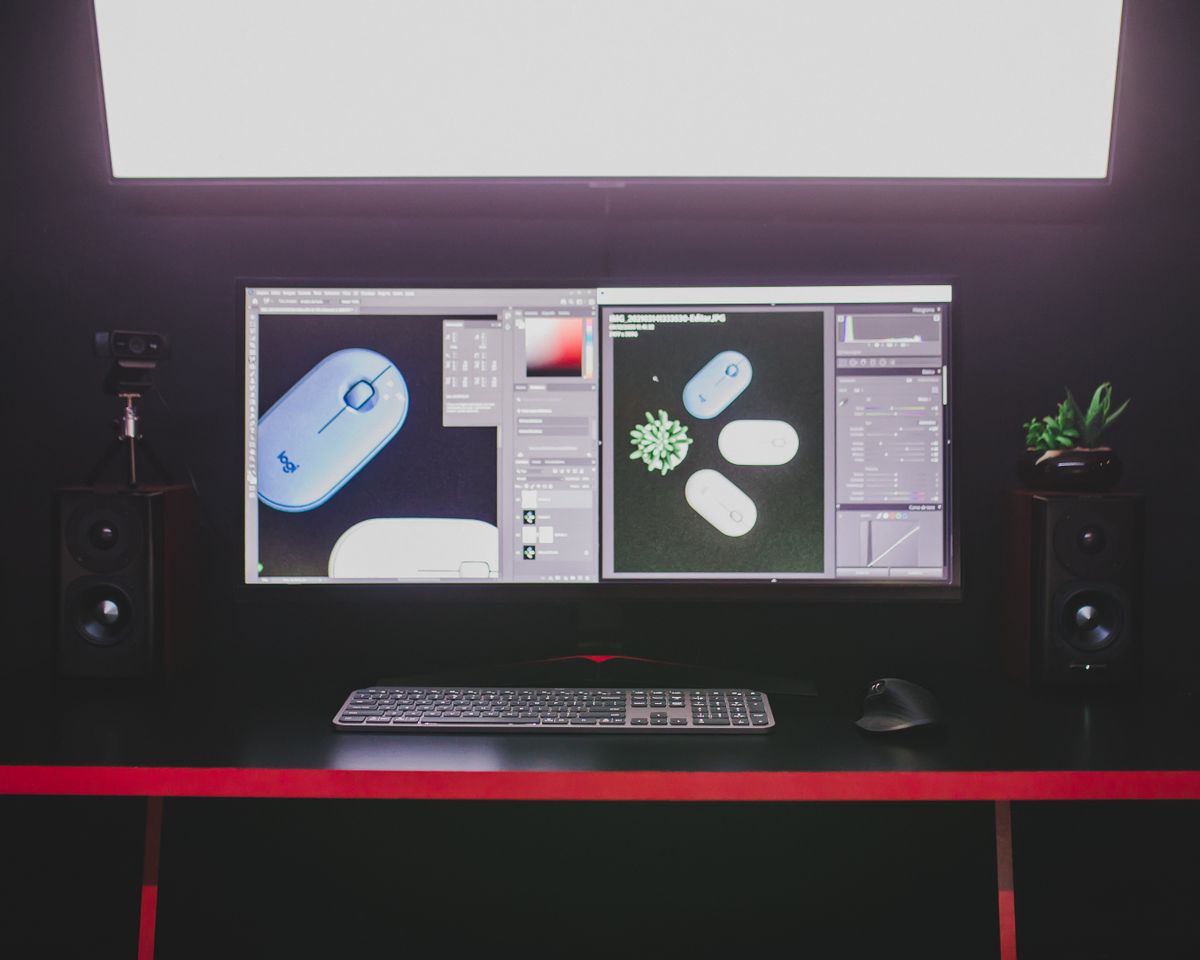 An editing desk with dual monitors showing a video timeline