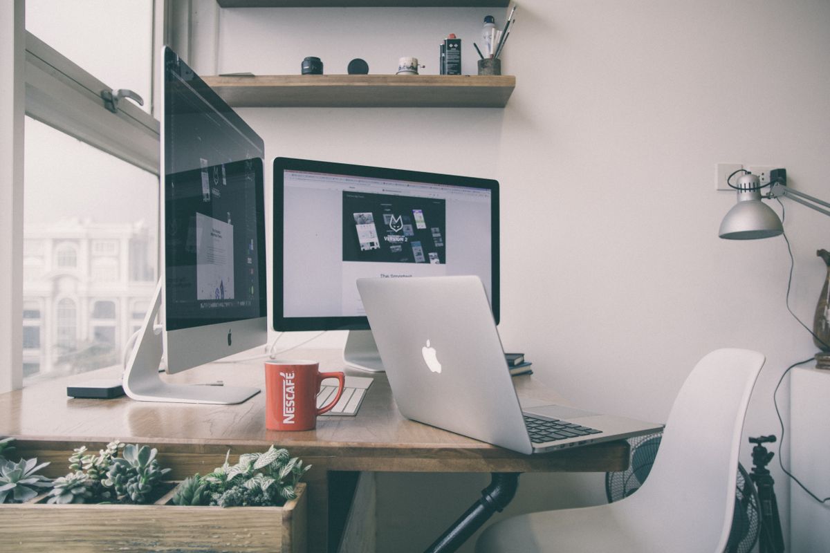 A freelance designer working alone at a tidy home desk