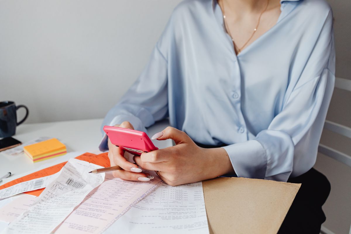 Paper receipts and a calculator spread across a desk