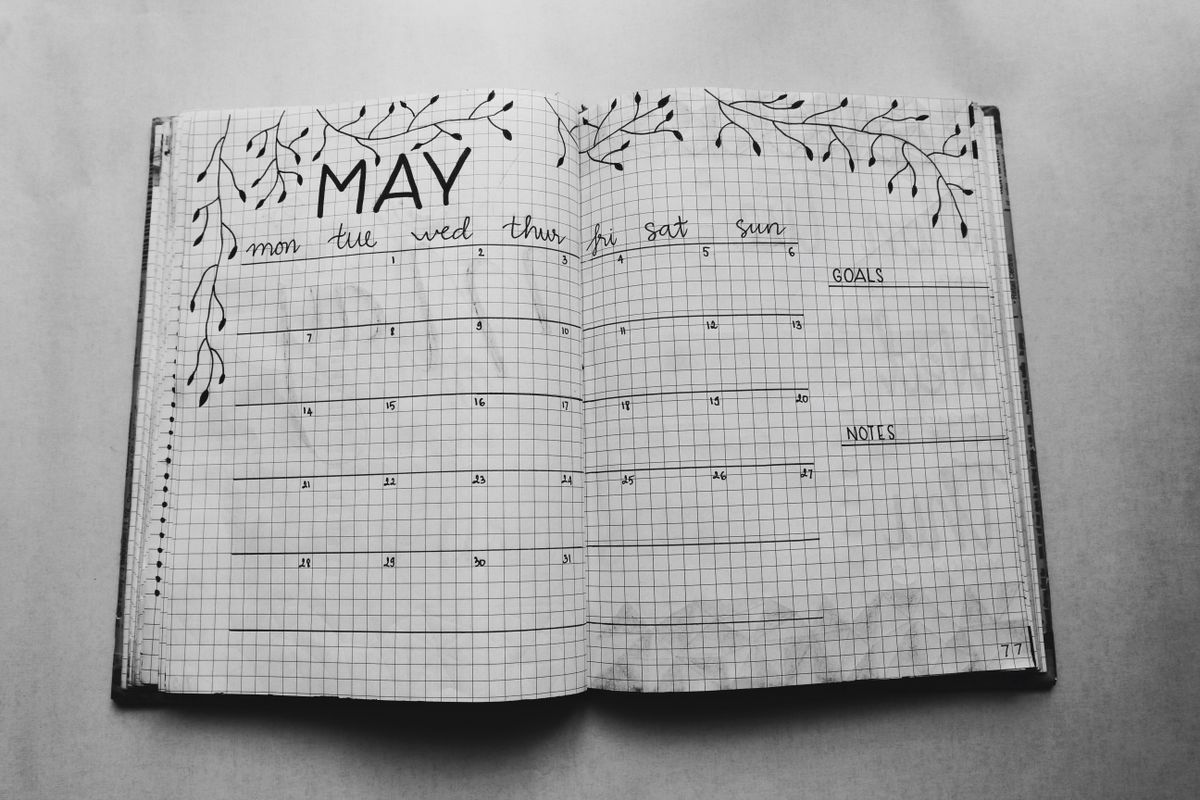 A notebook and calendar used for planning