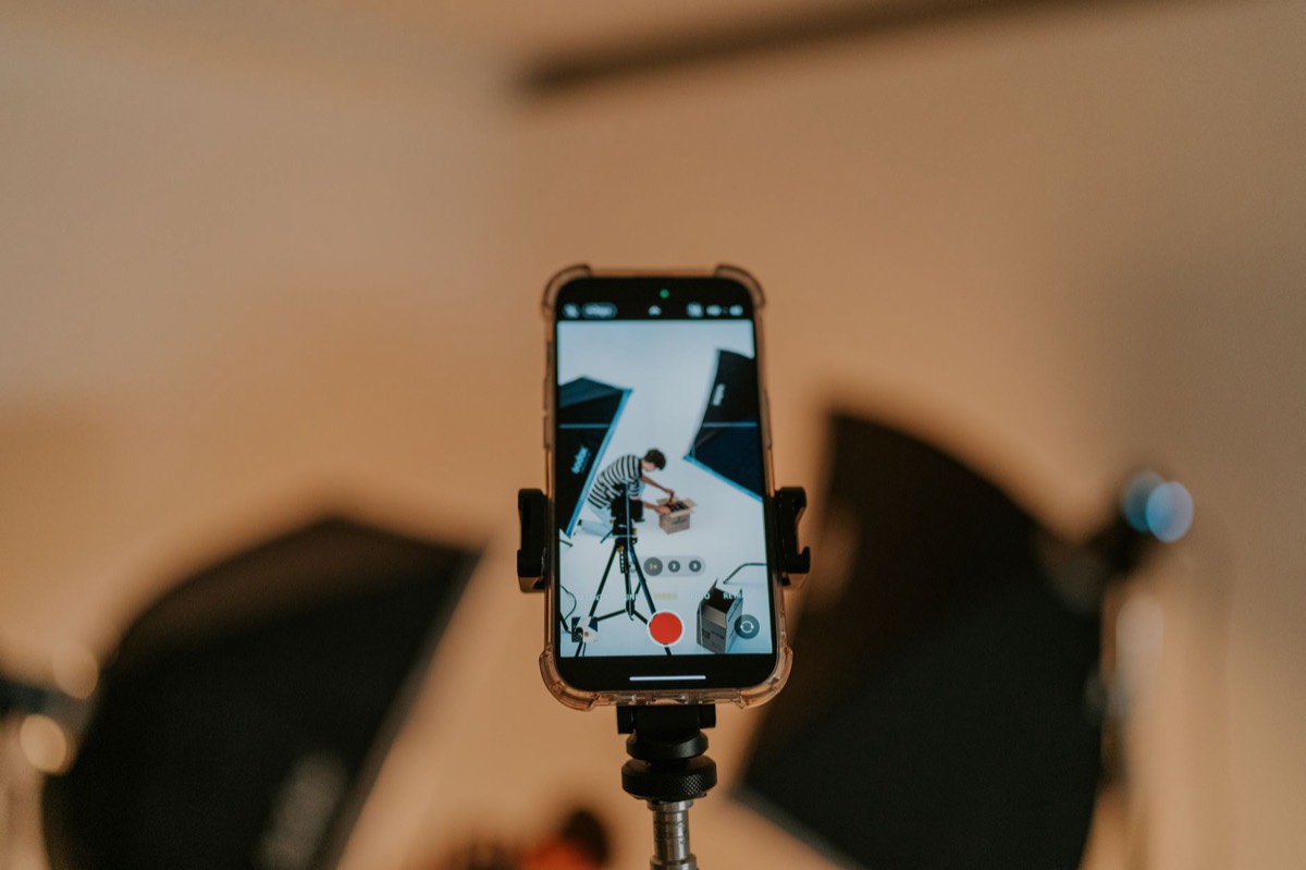 A phone held upright on a tripod, recording a shoot in portrait — the format the whole post is about