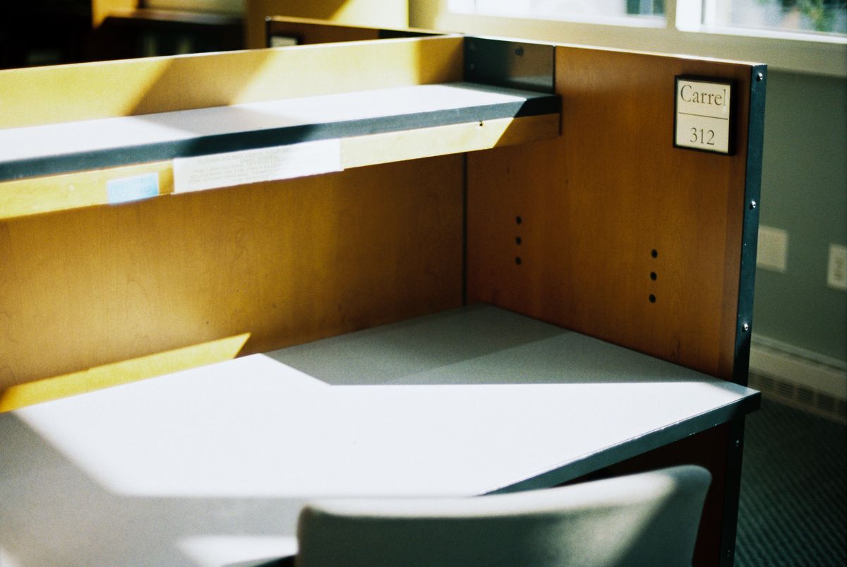 An empty office with afternoon light falling across the desks