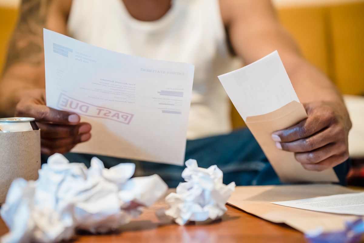 A scatter of paper receipts spread across a wooden desk