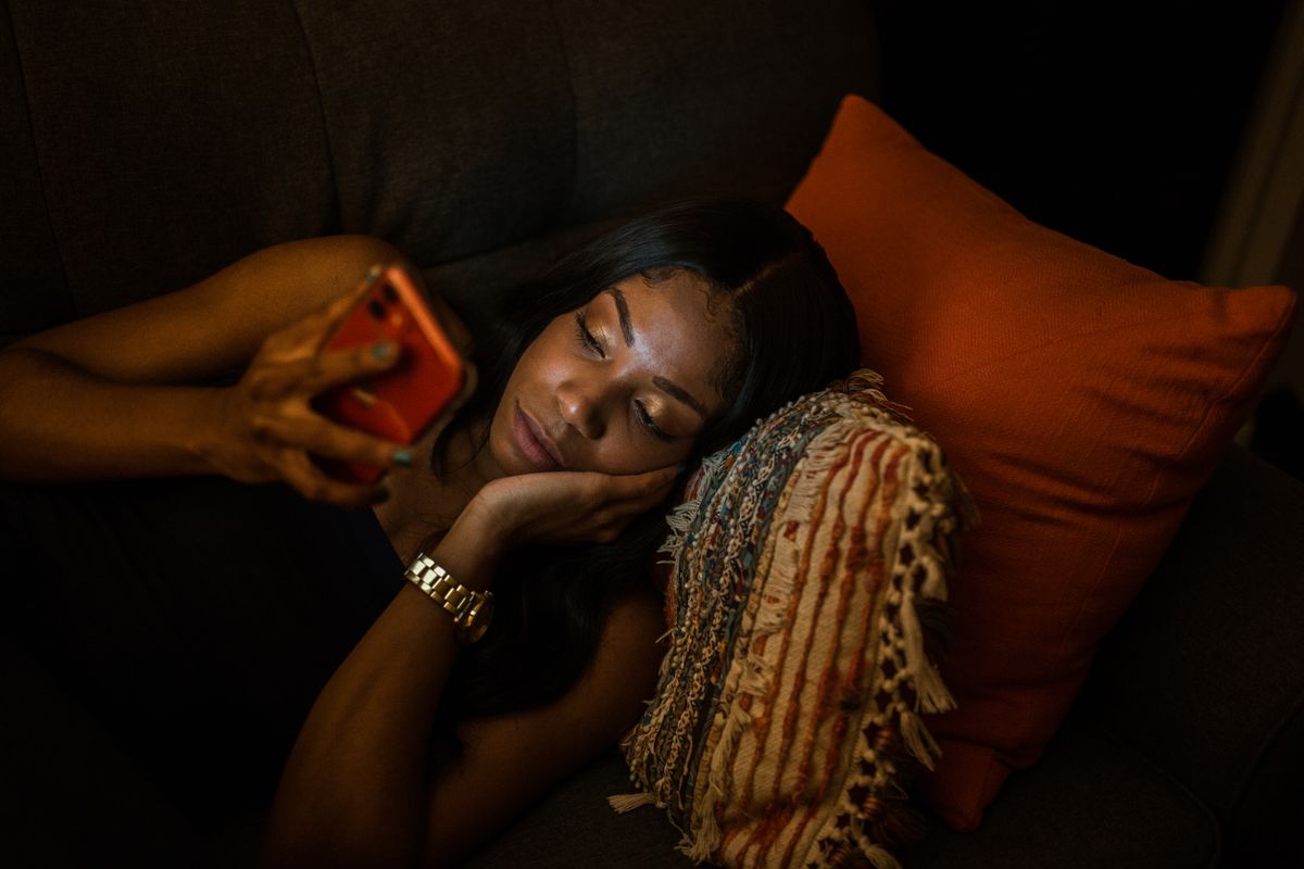 Someone relaxing and watching something on their phone