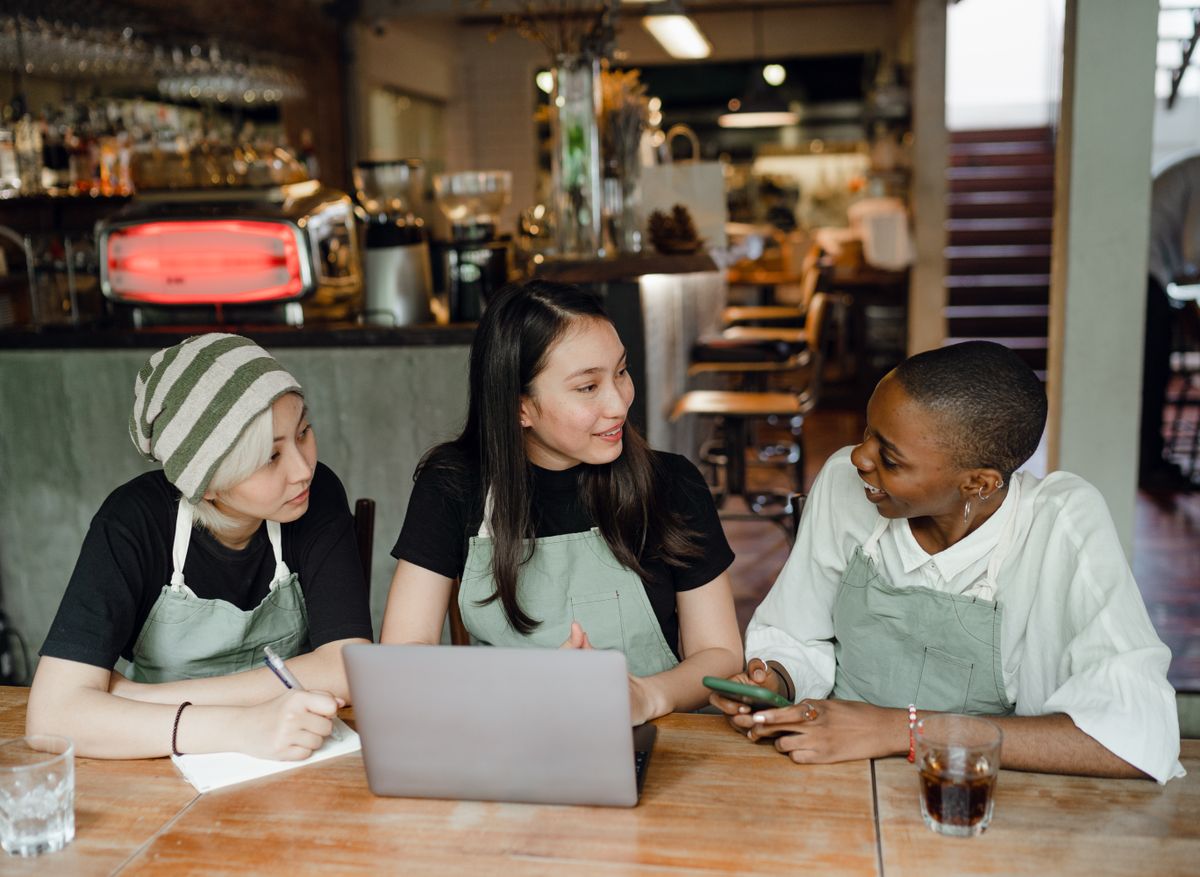 A small team looking at a website on a laptop